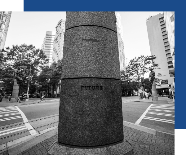 A black and white photo of a street corner.